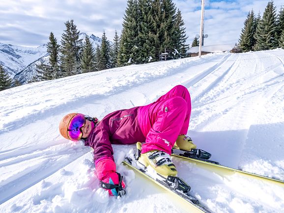 Winter in Lechtal - Alpine skiing child lies in the snow